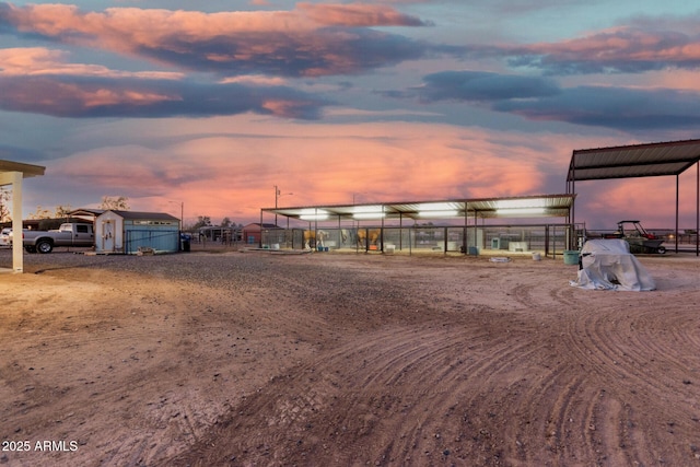 yard at dusk featuring a storage unit