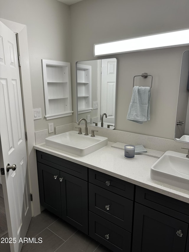 bathroom with double vanity, tile patterned floors, and a sink