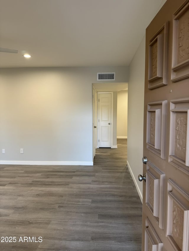 interior space featuring dark wood-style floors, recessed lighting, baseboards, and visible vents