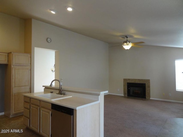 kitchen with a kitchen island with sink, a ceiling fan, a sink, light countertops, and dishwasher