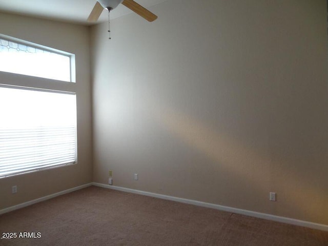 spare room with baseboards, a ceiling fan, and carpet flooring