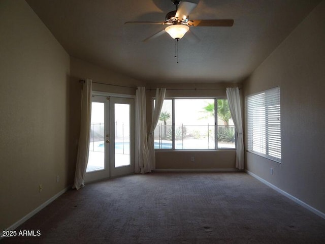 unfurnished room featuring french doors, baseboards, carpet, and vaulted ceiling