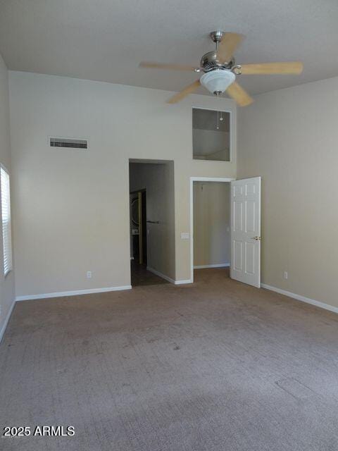 spare room featuring visible vents, baseboards, carpet floors, and ceiling fan