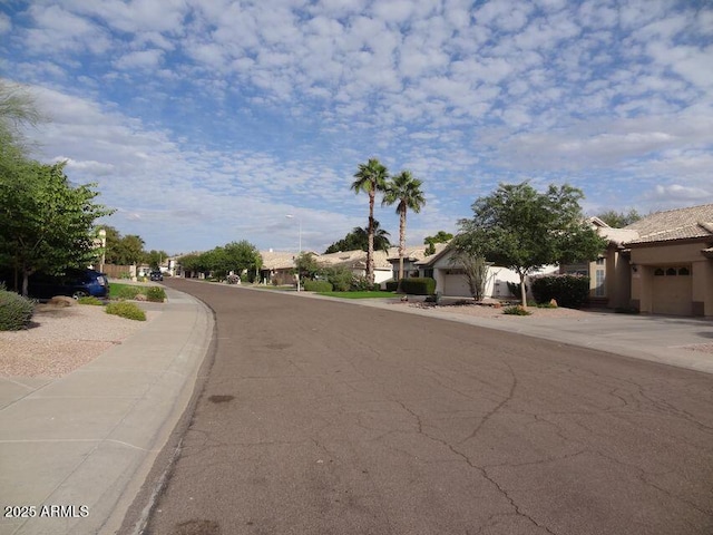 view of road featuring a residential view and street lights