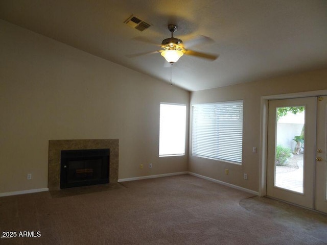 unfurnished living room with vaulted ceiling, a ceiling fan, visible vents, and carpet floors