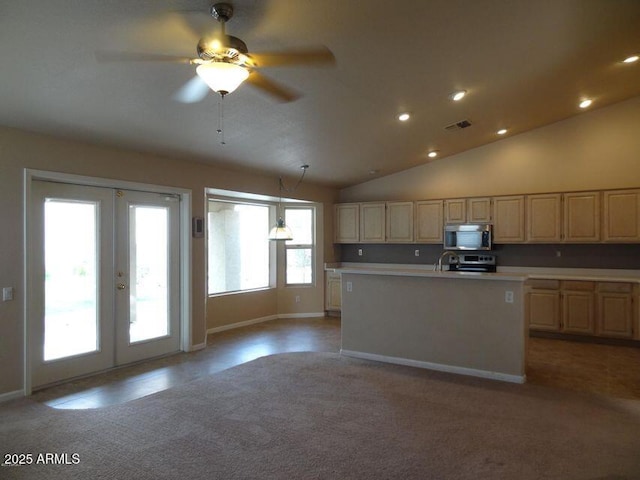 kitchen featuring french doors, appliances with stainless steel finishes, light brown cabinetry, and light countertops