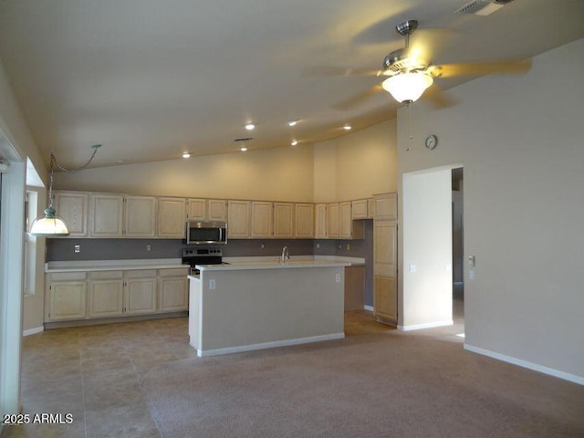 kitchen with baseboards, ceiling fan, light countertops, stainless steel appliances, and a kitchen island with sink