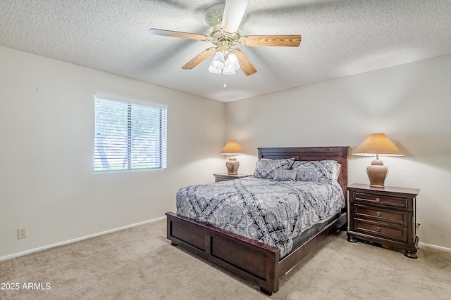 bedroom featuring a textured ceiling, ceiling fan, and light colored carpet