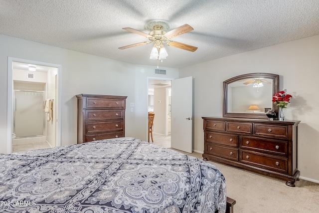 carpeted bedroom with ceiling fan, a walk in closet, a closet, and a textured ceiling