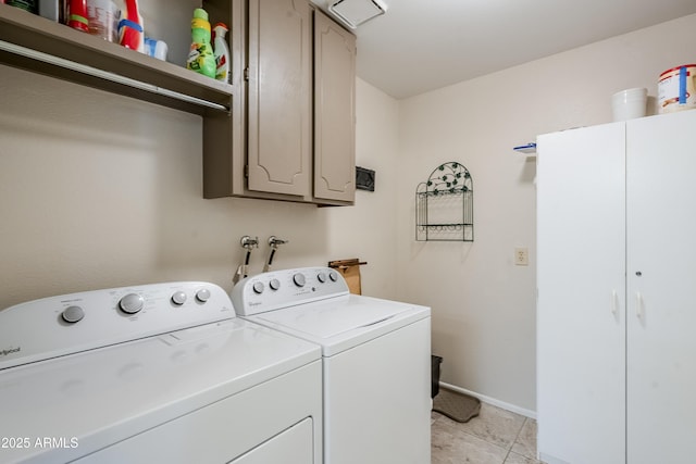 washroom featuring washer and clothes dryer, light tile patterned floors, and cabinets