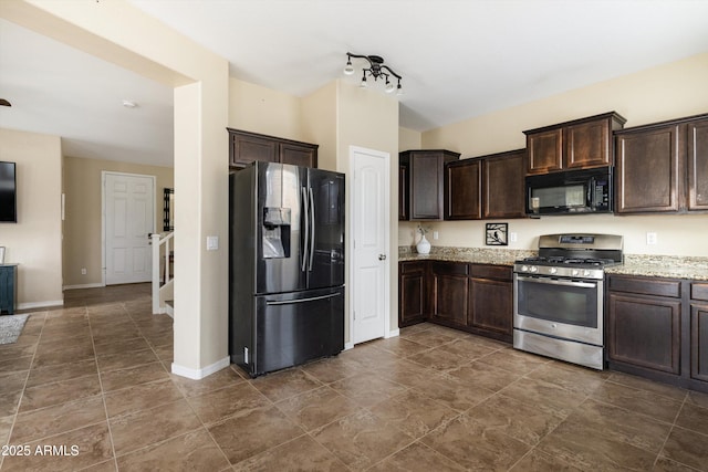 kitchen with stainless steel appliances, dark brown cabinetry, baseboards, and light stone countertops