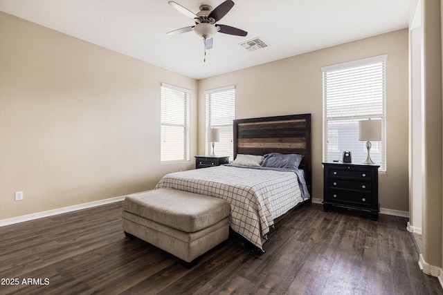 bedroom with dark wood-type flooring, baseboards, multiple windows, and ceiling fan