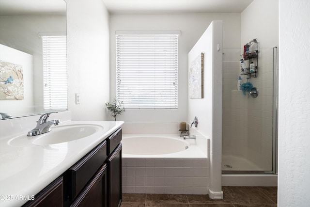 full bath featuring a stall shower, a bath, vanity, and tile patterned floors
