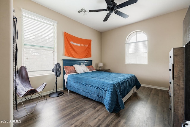 bedroom featuring wood finished floors, baseboards, and a ceiling fan