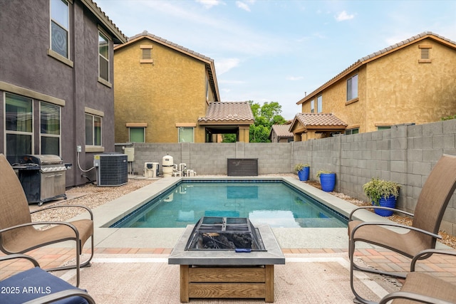 view of pool featuring central air condition unit, an outdoor fire pit, a grill, and a patio area