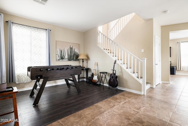 sitting room with stairway and baseboards