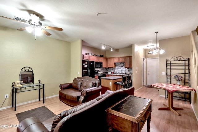 1718 W Colter St Unit 126, Phoenix, AZ 85015 - living room with light wood-style flooring, a chandelier, a ceiling fan, and baseboards