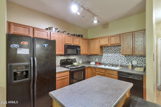 1718 W Colter St Unit 126, Phoenix, AZ 85015 - kitchen featuring black appliances, a sink, tasteful backsplash, a center island, and rail lighting