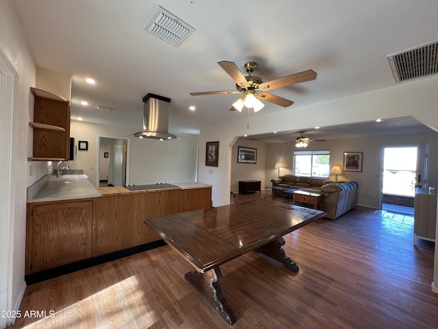 dining room with dark hardwood / wood-style floors, sink, and ceiling fan