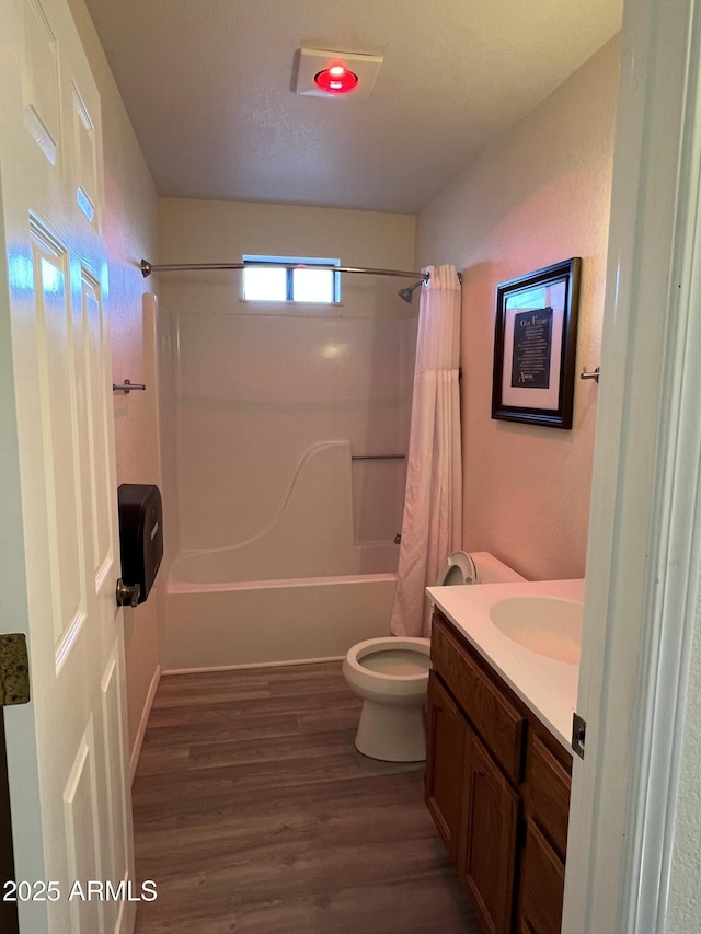 full bathroom with vanity, wood-type flooring, toilet, and shower / tub combo with curtain