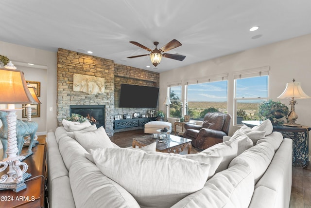 living room featuring hardwood / wood-style flooring, a fireplace, and ceiling fan