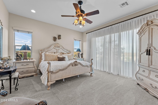 bedroom featuring light carpet and ceiling fan