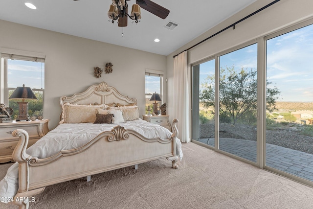 bedroom with multiple windows, carpet, access to exterior, and ceiling fan