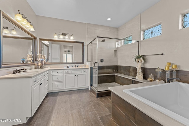 bathroom featuring vanity, wood-type flooring, and shower with separate bathtub