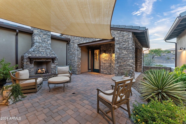 view of patio featuring an outdoor stone fireplace