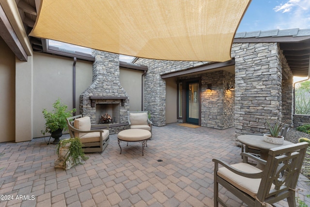 view of patio featuring an outdoor stone fireplace