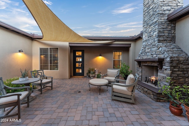 view of patio featuring an outdoor stone fireplace