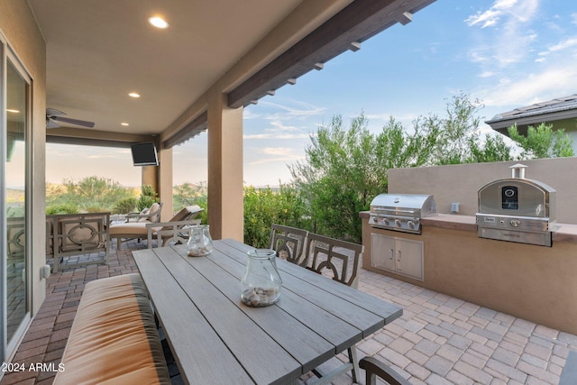 view of patio featuring an outdoor kitchen and a grill