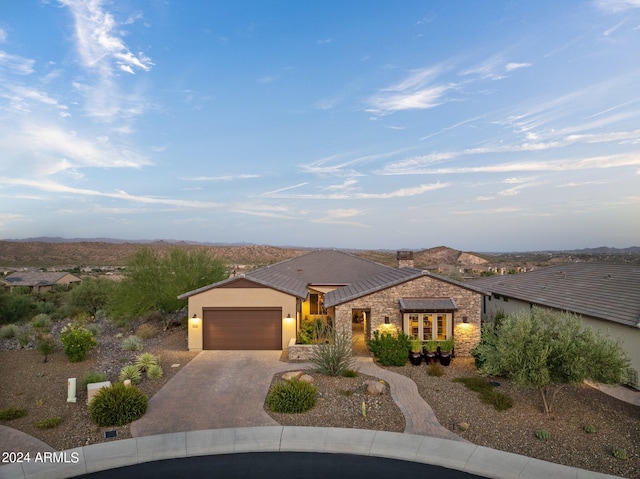 view of front of property featuring a mountain view and a garage