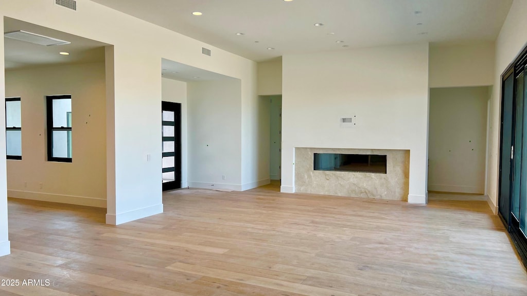 13206 E Buckskin Trl, Scottsdale, AZ 85255 - unfurnished living room featuring light wood-style flooring, baseboards, a fireplace, and recessed lighting