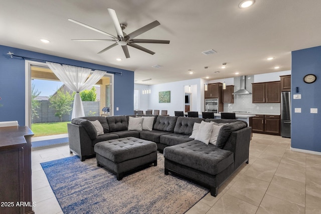 tiled living room with ceiling fan