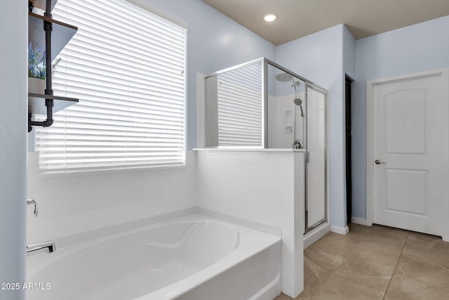 bathroom with plus walk in shower, tile patterned flooring, and a wealth of natural light