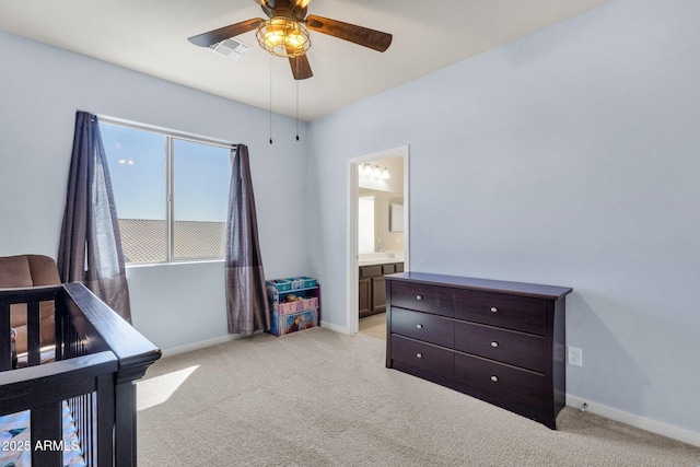 bedroom featuring connected bathroom, ceiling fan, and light carpet