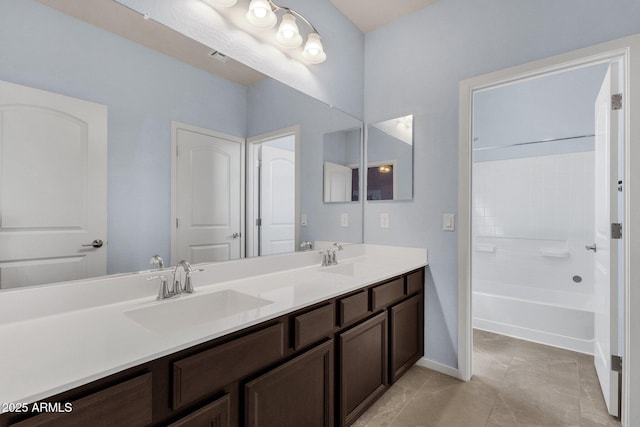 bathroom featuring tile patterned flooring, vanity, and shower / bathtub combination