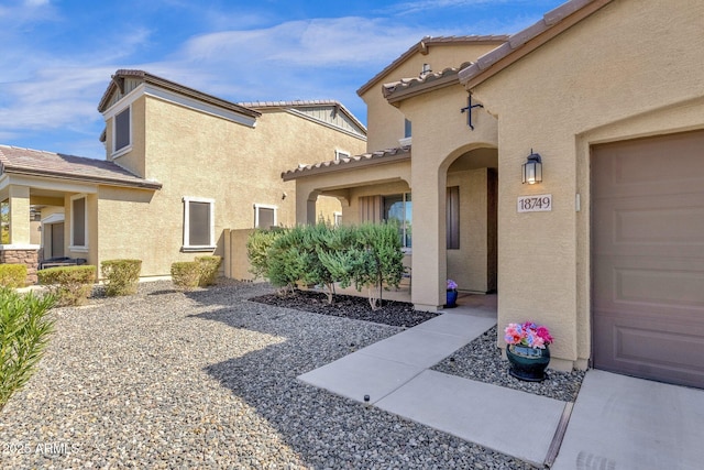 view of exterior entry featuring a garage