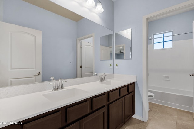 full bathroom with tile patterned flooring, vanity, shower / bath combination, and toilet