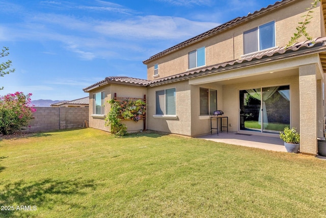 back of property featuring a yard and a patio