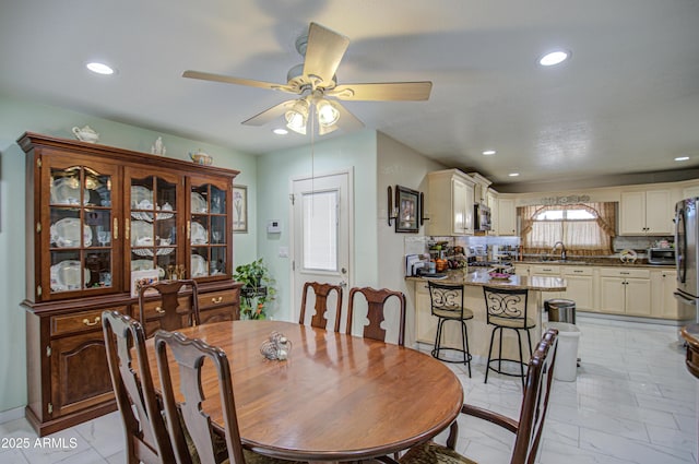 dining room with sink and ceiling fan