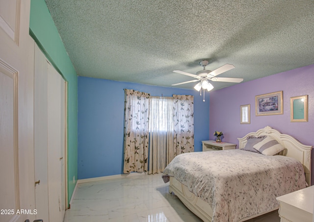 bedroom featuring ceiling fan, a closet, and a textured ceiling