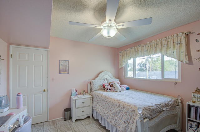 bedroom with ceiling fan and a textured ceiling