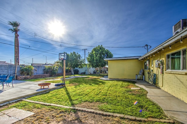 view of yard featuring a fire pit and a patio