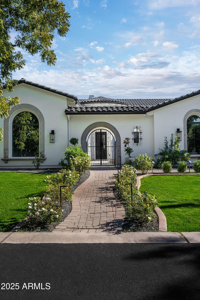 exterior space featuring french doors and a lawn