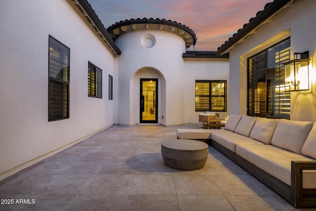 patio terrace at dusk with an outdoor living space