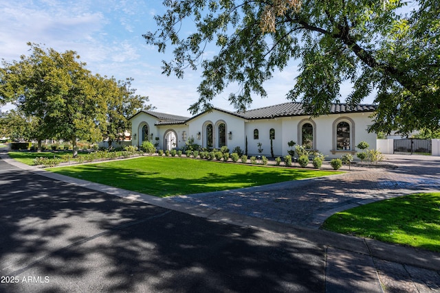 mediterranean / spanish house with a front yard