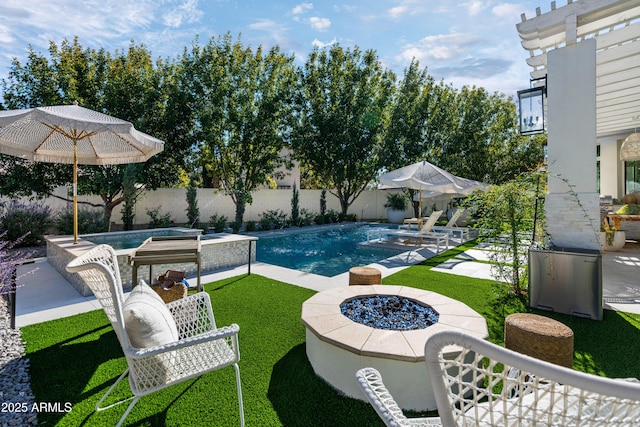 view of pool featuring an in ground hot tub, a lawn, a patio area, and an outdoor fire pit