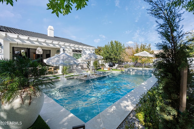 view of swimming pool featuring pool water feature and a patio area